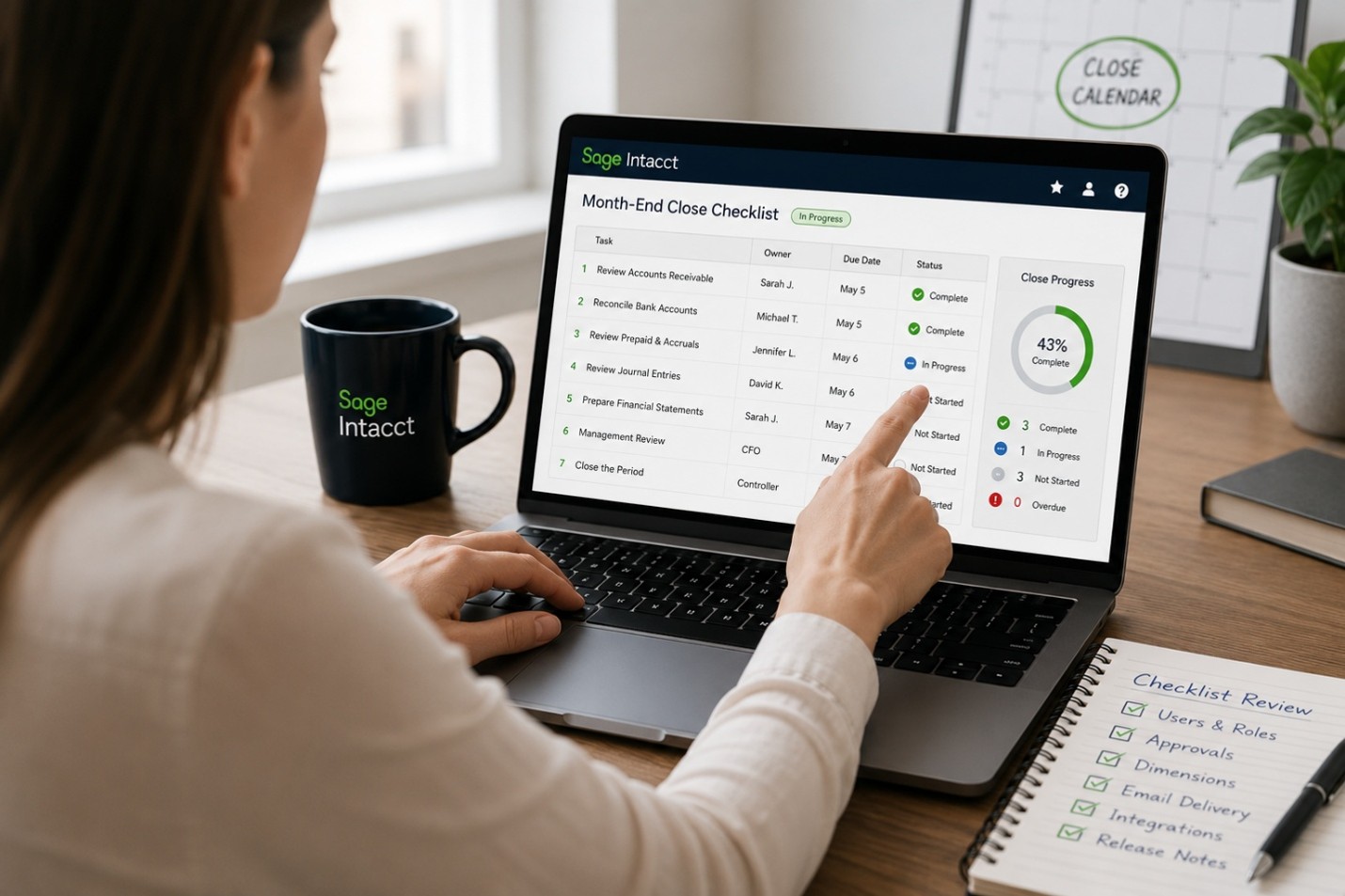 A Woman Pointing at a Computer Screen with Sage Month End Close Dashboard Displayed